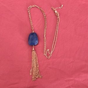 Long gold necklace with blue stone
